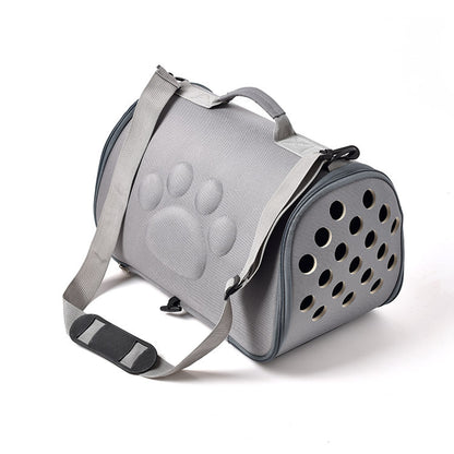 Gray pet carrier with paw print design on a white background