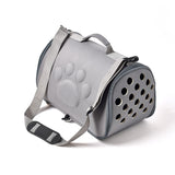 Gray pet carrier with paw print design on a white background