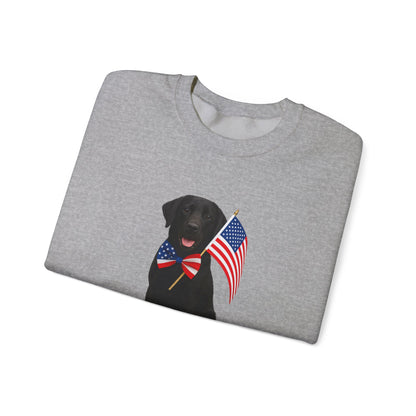 Folded graysweatshirt with a black labrador wearing a USA flag bow tie on a white background