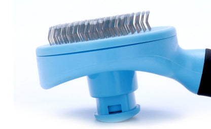 Blue pet grooming brush with metal teeth on a white background