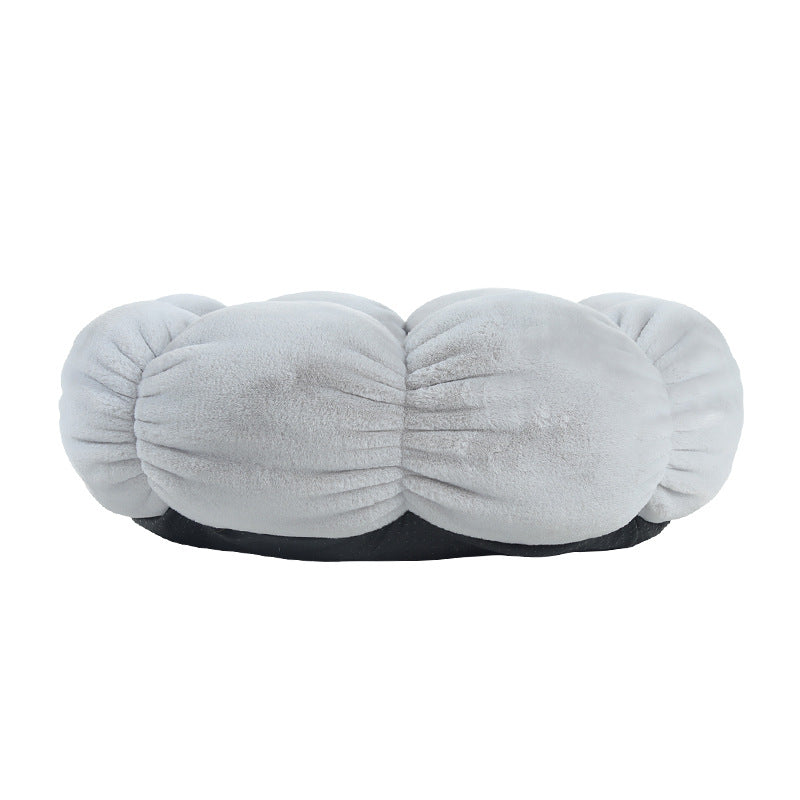 Gray plush cushion with a black base on a white background