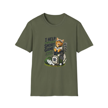 A military green graphic T-shirt is displayed in a styled flat lay on a light beige surface. The shirt features a cartoon cat wearing a baseball cap and holding golf clubs, with the text 'I HELP WITH YOUR SHORT GAME BY STEALING GOLF BALLS.