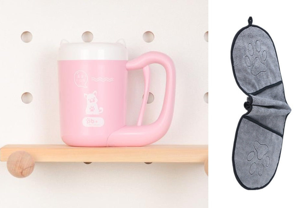 Pink mug on a wooden shelf with a gray bat-shaped towel hanging on a pegboard.