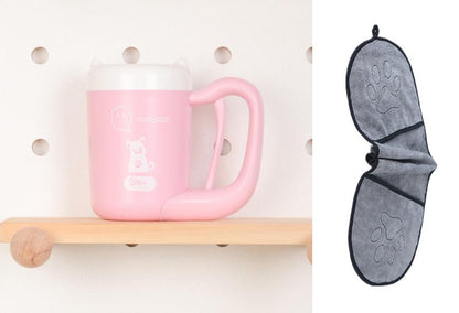 Pink mug on a wooden shelf with a gray bat-shaped towel hanging on a pegboard.