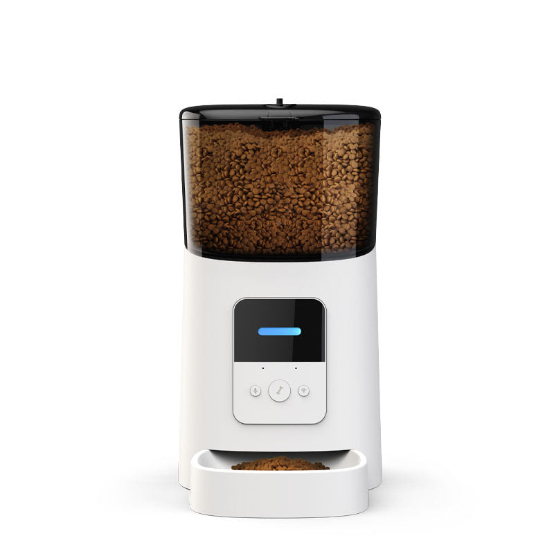 White pet food dispenser with a black top filled with dog food on a white background