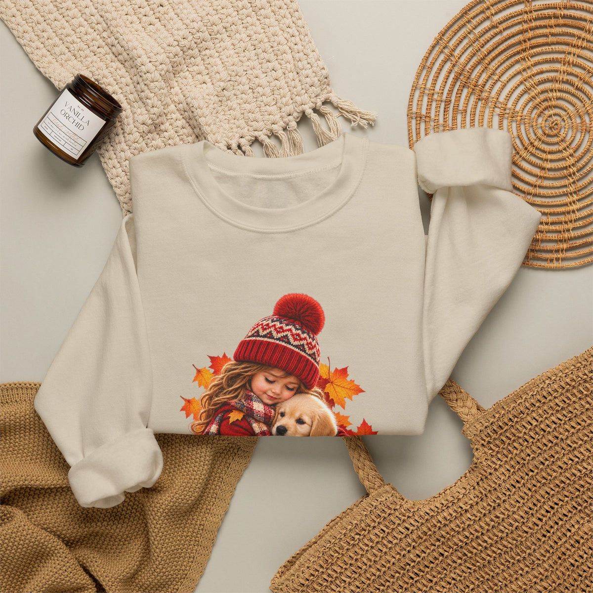 Folded sand Golden Moments girl and puppy sweatshirt styled with neutral knit accessories