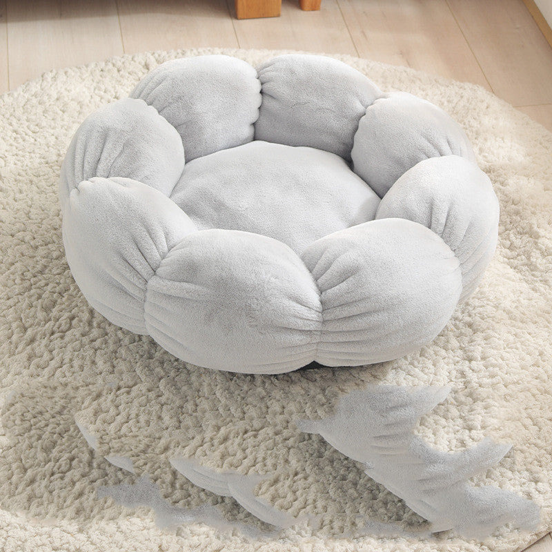 Round, plush pet bed on a fluffy rug with shark toys nearby
