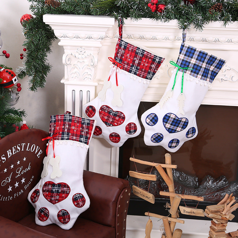 Paw-shaped Christmas stockings displayed beside a decorated holiday fireplace