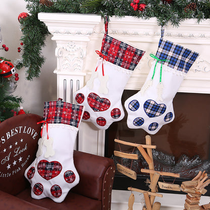 Paw-shaped Christmas stockings displayed beside a decorated holiday fireplace