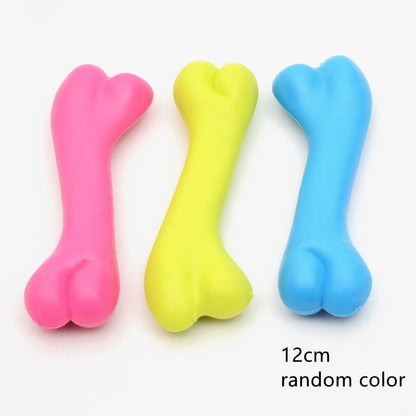 Three colorful bone-shaped toys in pink, yellow, and blue on a white background.