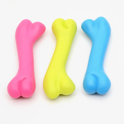 Three colorful bone-shaped toys on a white background