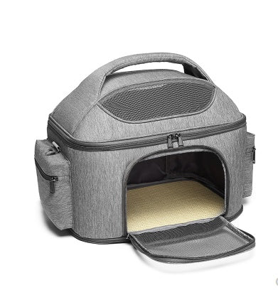 Gray pet carrier with open door on a white background