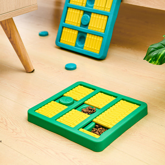 Two puzzle toys on a wooden floor with a green base and yellow compartments.