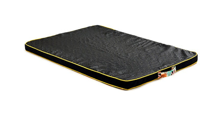 Dog bed with black surface and yellow border on a white background