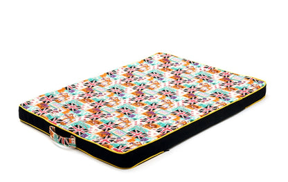 Colorful patterned pet bed on a white background