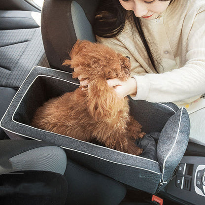 Person petting a small brown dog inside a car seat cover
