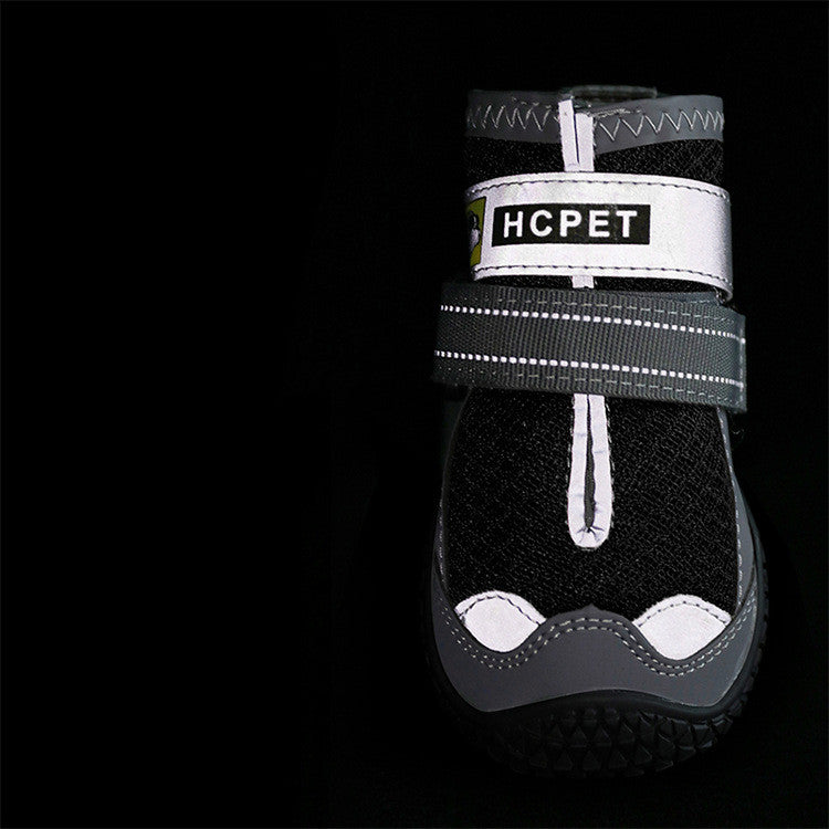Black pet boot with white sole and 'HCPET' label on a black background