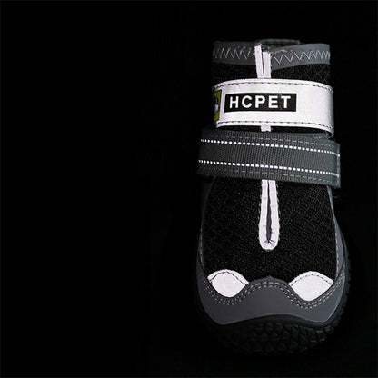 Black pet boot with white sole and 'HCPET' label on a black background