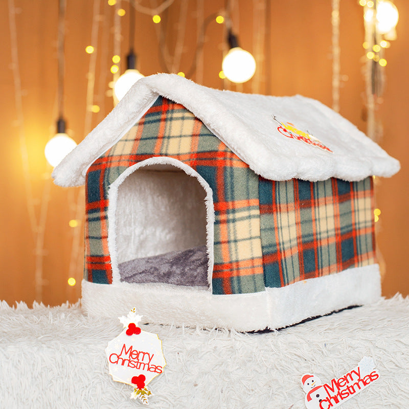 Plaid pet house with white roof on a soft surface, Christmas decorations around