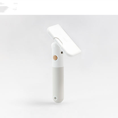White cleaning tool with a gold accent on a light gray background