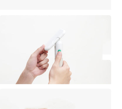 Two hands holding a white electronic device with a green button on a white background