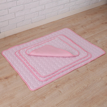 Set of pink bath mats on a wooden floor with a white brick wall background