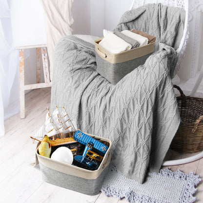 Gray textured blanket draped over a chair with toys in a basket below.