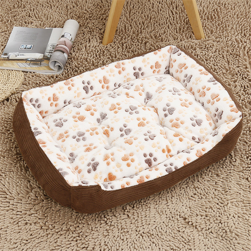 Pet bed with paw print pattern on a carpeted floor