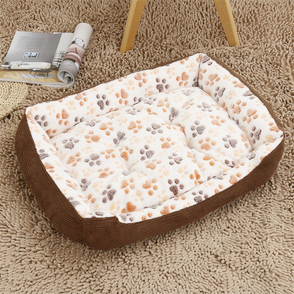 Pet bed with paw print pattern on a carpeted floor