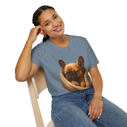 Person wearing a blue t-shirt with a dog design, sitting on a chair.