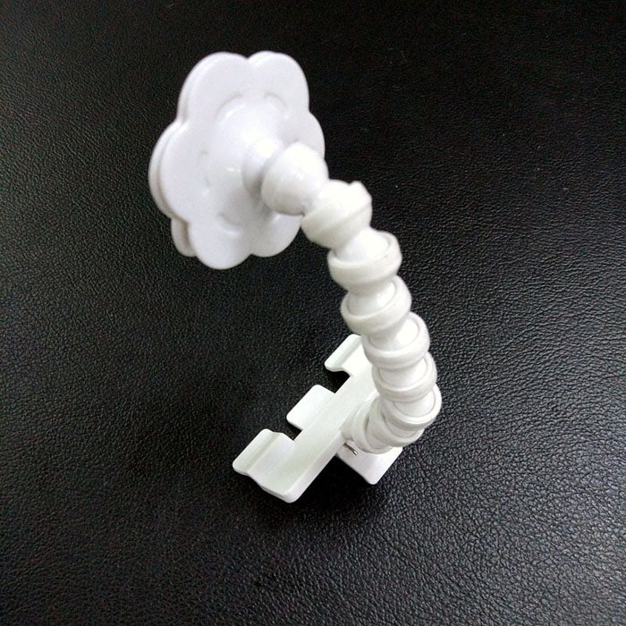 White flexible camera mount on a black background