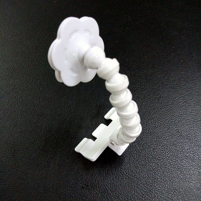 White flexible camera mount on a black background