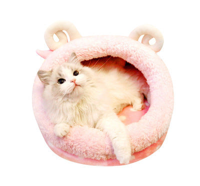 Cat inside a pink pet house with bear ears on a white background