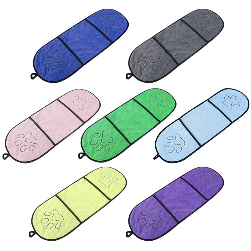 Set of colorful pet car seat covers with paw prints on a white background