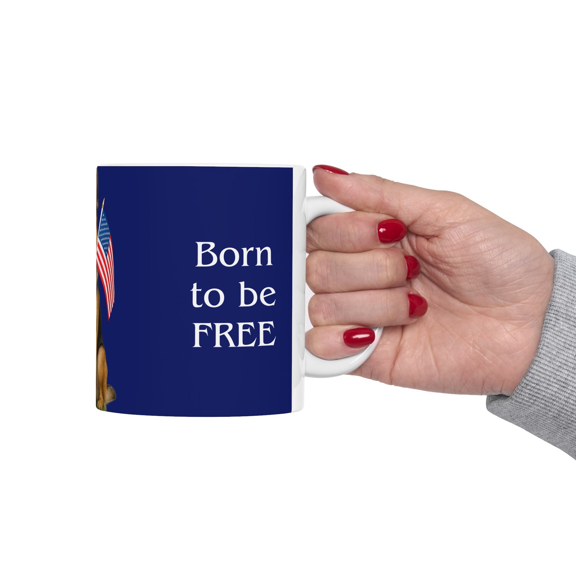 Mug with 'Born to be FREE' text held by a hand with red nail polish on a white background