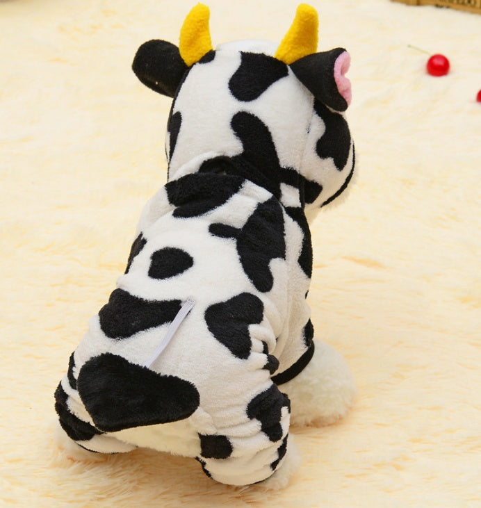 Plush cow toy on a light brown surface