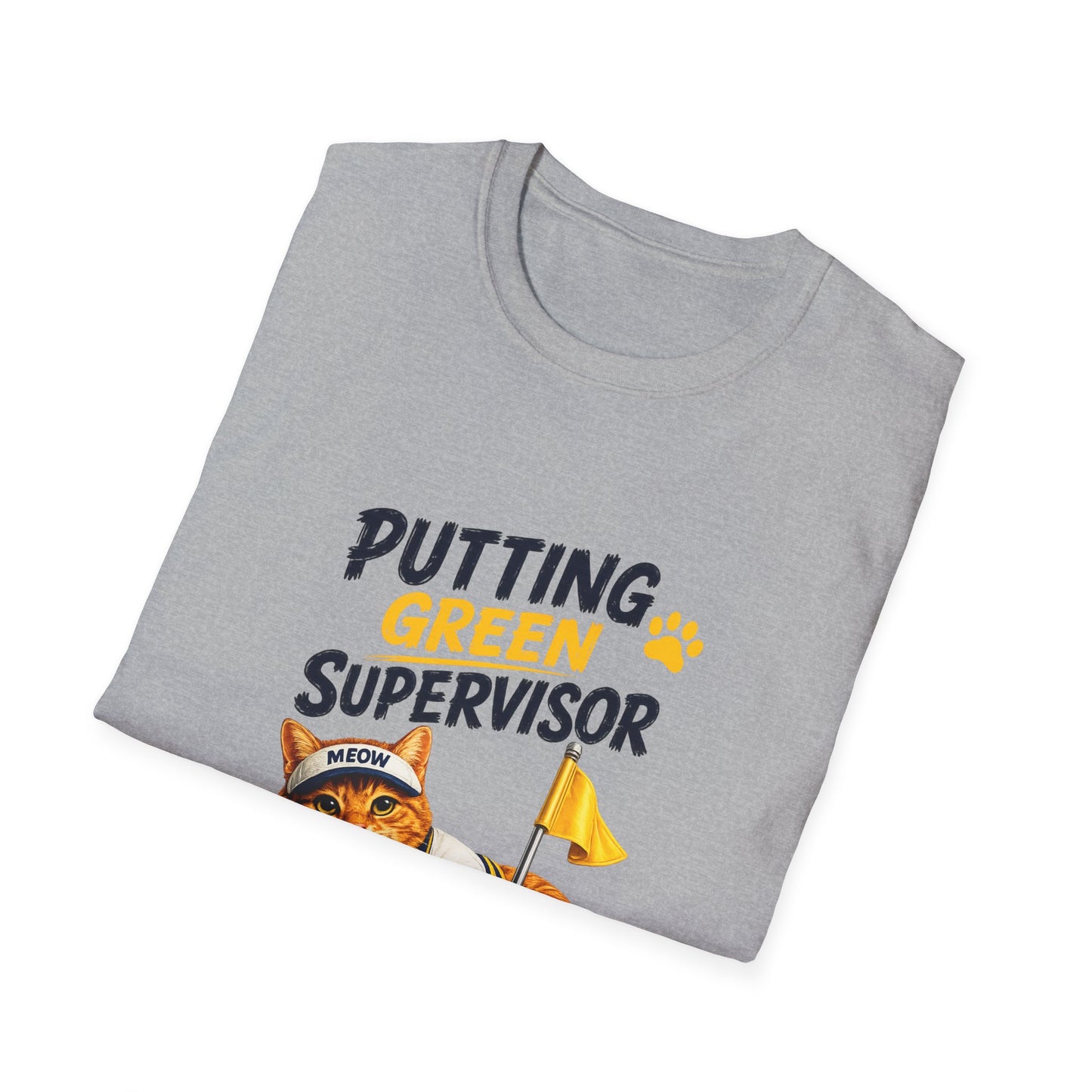 A folded light gray t-shirt with a graphic print that reads 'PUTTING GREEN SUPERVISOR' in black and yellow text, featuring an illustration of an orange tabby cat wearing a headband and holding a yellow flag.