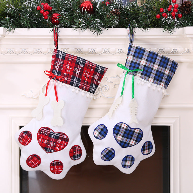 Red and blue plaid paw-shaped Christmas stockings hanging side by side