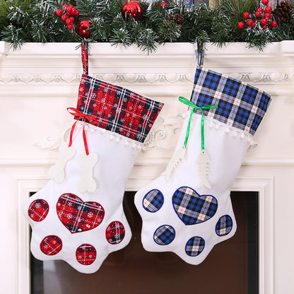 Red and blue plaid paw-shaped Christmas stockings hanging side by side