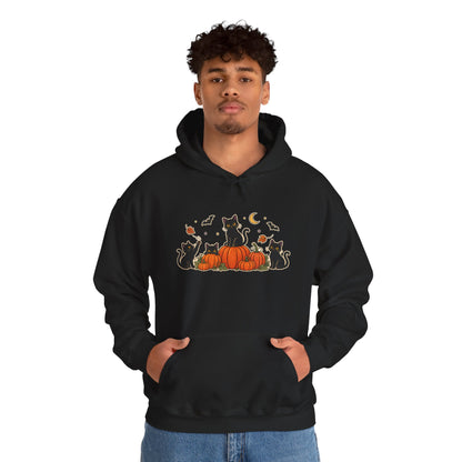 A black pullover hoodie with a front graphic of black cats sitting on orange pumpkins, surrounded by small bats, leaves, and a crescent moon, shown on a plain white background.