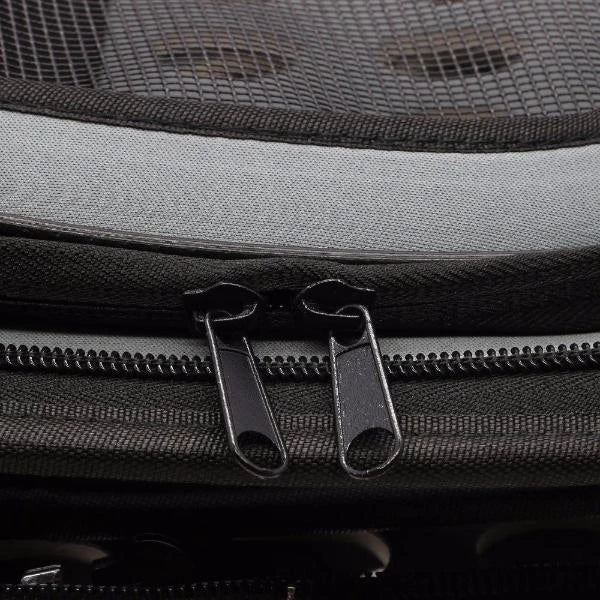 Close-up of a gray backpack with zippers and mesh pocket