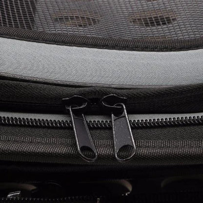 Close-up of a gray backpack with zippers and mesh pocket