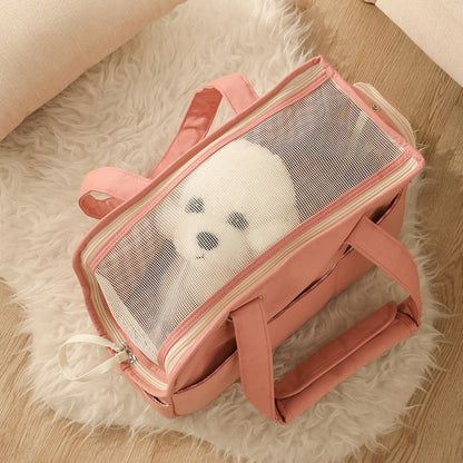 Pink pet carrier with transparent window on a fluffy white rug