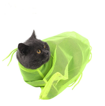 Cat peeking out from a green mesh bag on a white background