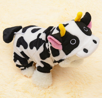 Plush cow toy with black and white pattern on a yellow background