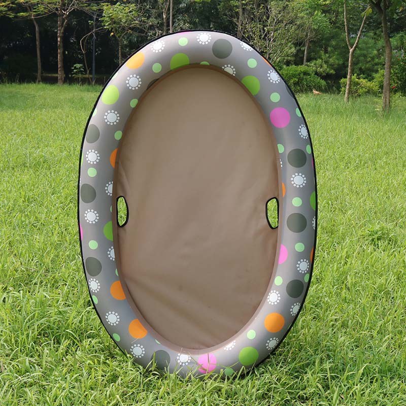 Inflatable playpen with colorful polka dot design on grass