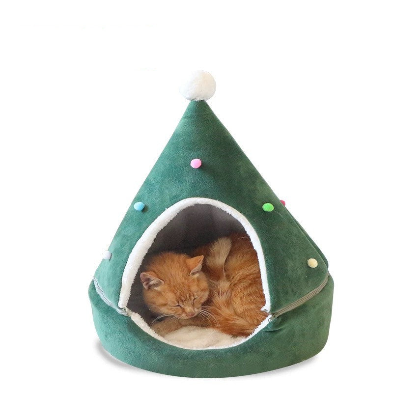 Green pet bed shaped like a Christmas tree with a cat inside on a white background