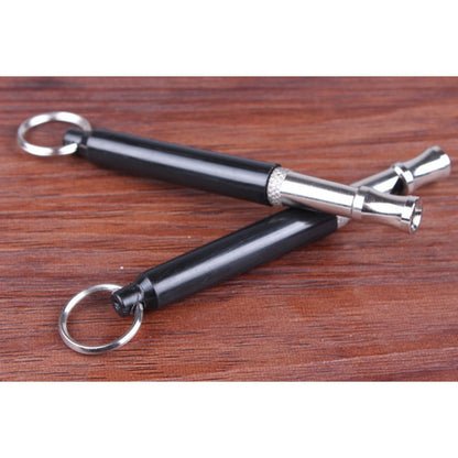 Black and silver tool with keychain on a wooden surface