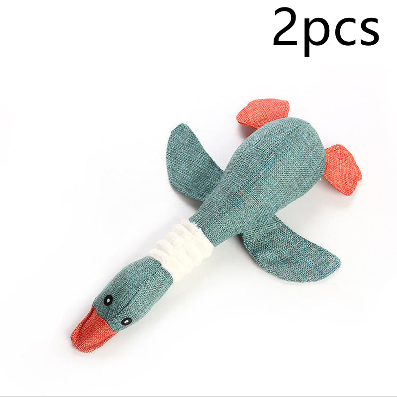 Two green duck-shaped toys with red beaks on a white background
