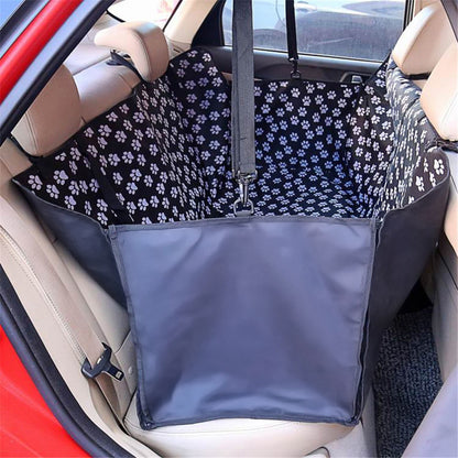 Car seat cover with paw print pattern installed in a vehicle